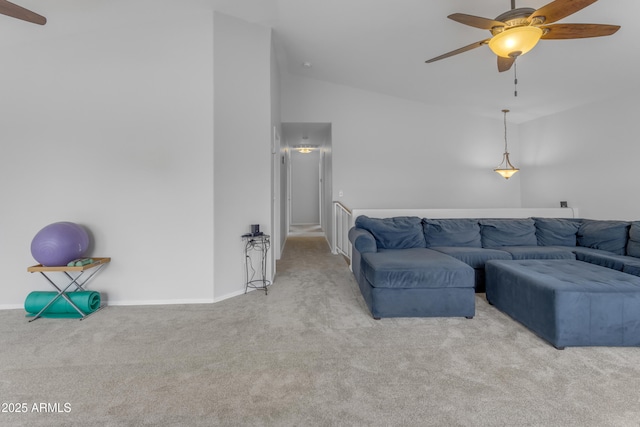 carpeted living room featuring lofted ceiling, ceiling fan, and baseboards