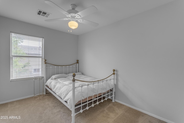 bedroom with carpet, visible vents, and baseboards