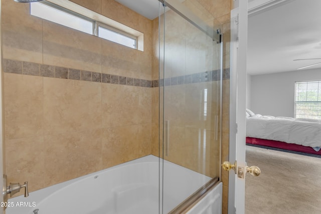 ensuite bathroom with ceiling fan, ensuite bathroom, and bath / shower combo with glass door