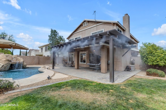 rear view of house with a fenced in pool, a fenced backyard, a chimney, a patio area, and stucco siding