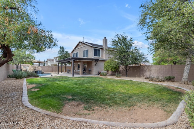 back of house featuring a fenced backyard, a patio, a chimney, and a lawn