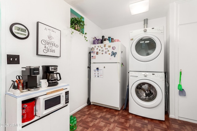 laundry area with dark parquet flooring and stacked washing maching and dryer