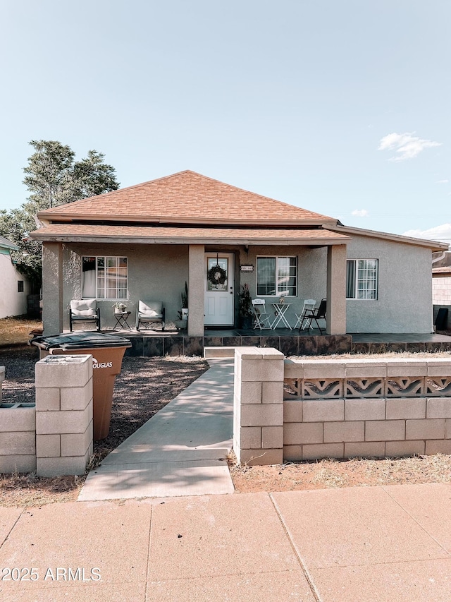 914 E 16th St, Douglas, AZ 85607 - bungalow-style house with covered porch, a fenced front yard, stucco siding, and roof with shingles