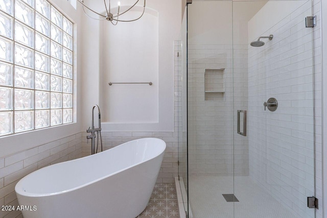 bathroom with tile patterned flooring, shower with separate bathtub, and tile walls