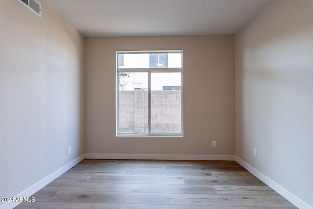 empty room with light hardwood / wood-style flooring