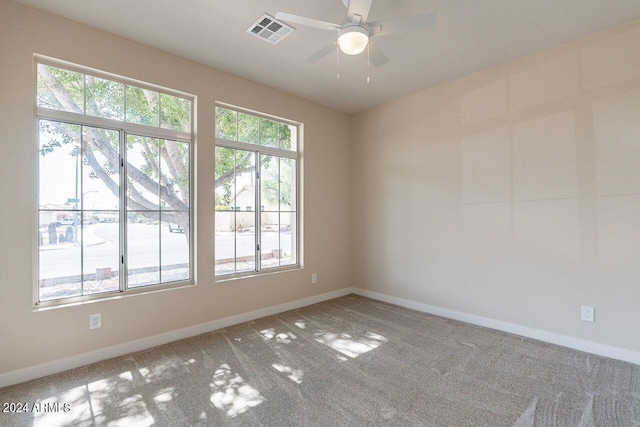 carpeted spare room featuring ceiling fan