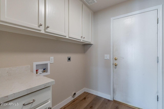 clothes washing area with hookup for an electric dryer, wood-type flooring, cabinets, and washer hookup