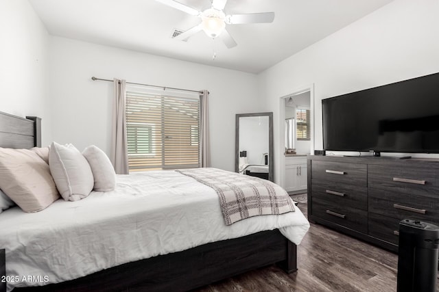 bedroom with ceiling fan, connected bathroom, visible vents, and dark wood-type flooring