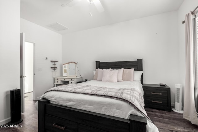 bedroom with baseboards, a ceiling fan, and dark wood-type flooring