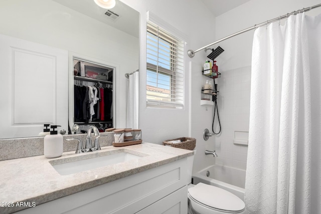 full bathroom with toilet, shower / bath combo, vanity, and visible vents