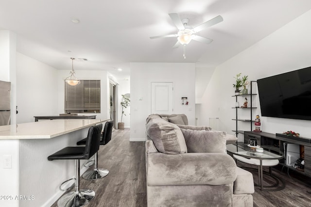 living room featuring a ceiling fan, dark wood finished floors, and baseboards