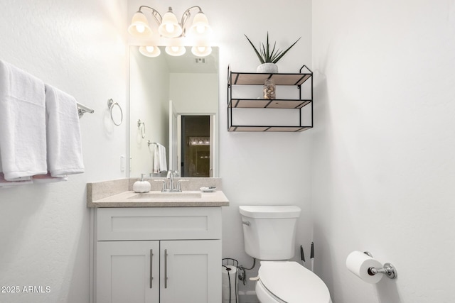 bathroom featuring toilet, visible vents, and vanity