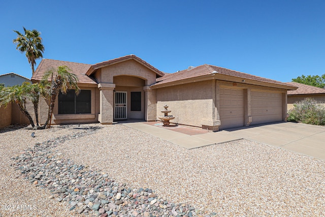 ranch-style home featuring a garage