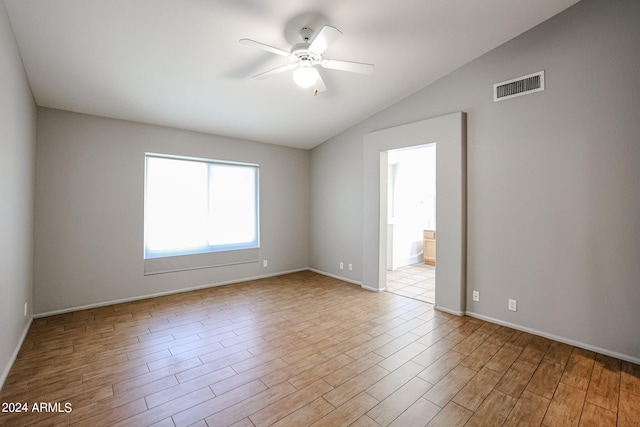 unfurnished room with lofted ceiling, ceiling fan, and light wood-type flooring