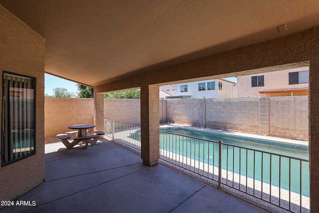 view of terrace with a fenced in pool