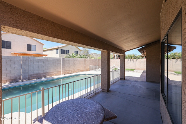 view of patio with a fenced in pool