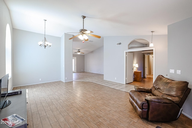 living room featuring lofted ceiling, light wood-type flooring, and ceiling fan with notable chandelier