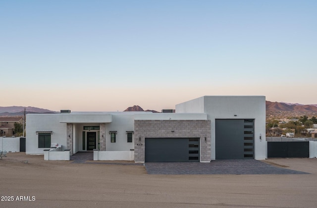 contemporary house with a garage and a mountain view