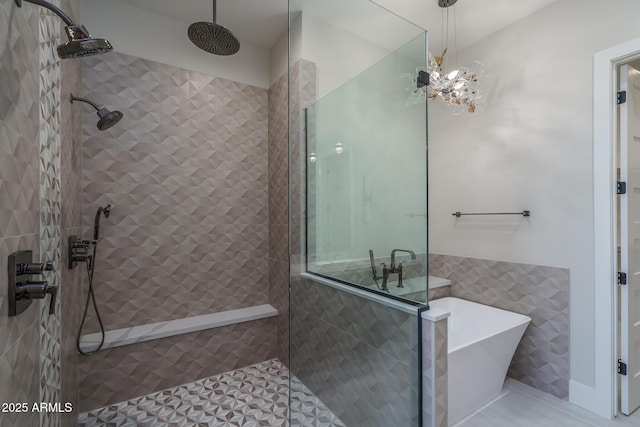 bathroom with independent shower and bath, tile walls, and a notable chandelier