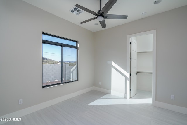 unfurnished room with ceiling fan