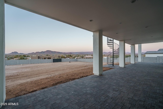 yard at dusk with a mountain view and a patio