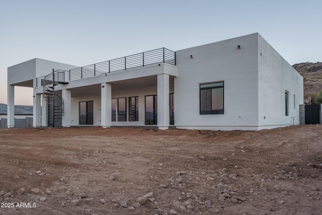 view of back house at dusk