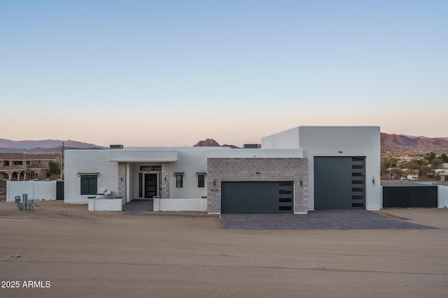 modern home featuring a garage and a mountain view