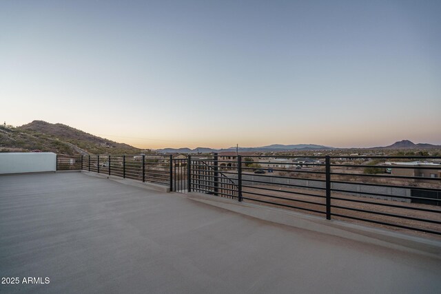 patio terrace at dusk with a mountain view