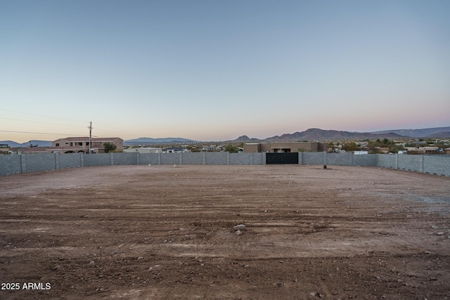 yard at dusk featuring a mountain view