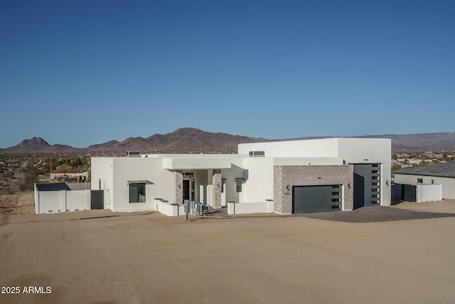 view of front of property with a mountain view and a garage