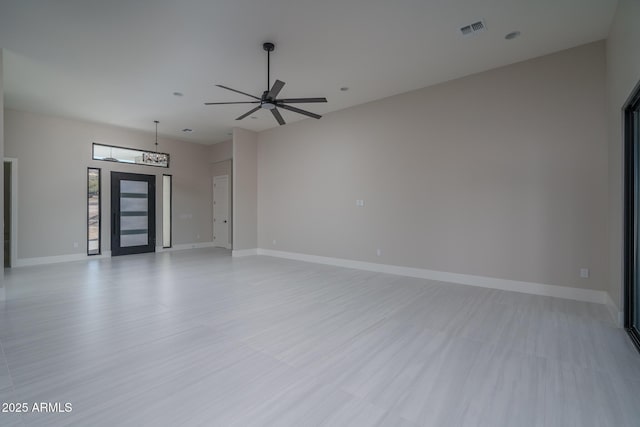 unfurnished living room featuring ceiling fan and light wood-type flooring