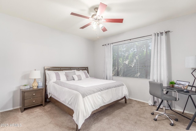 carpeted bedroom with ceiling fan and baseboards