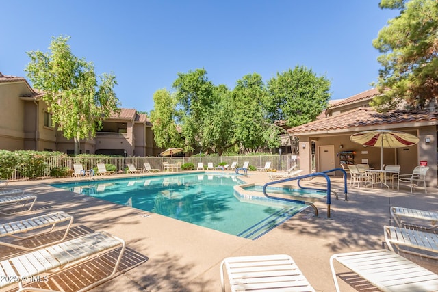 pool featuring fence and a patio area
