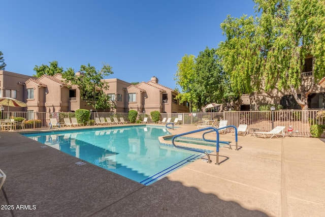 pool with a residential view, a patio, and fence