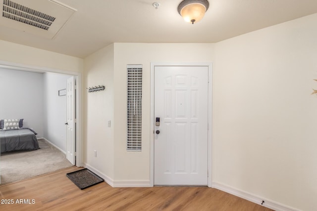 entryway featuring baseboards, visible vents, and light wood-style flooring