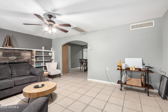 2064 W 2nd St, Mesa, AZ 85201 - living room featuring arched walkways, ceiling fan, light tile patterned floors, and baseboards