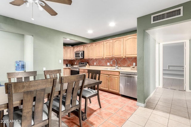 2064 W 2nd St, Mesa, AZ 85201 - kitchen with appliances with stainless steel finishes, a sink, light tile patterned floors, tasteful backsplash, and light countertops
