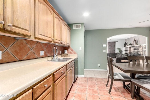 2064 W 2nd St, Mesa, AZ 85201 - kitchen with a sink, arched walkways, stainless steel dishwasher, light tile patterned floors, and light countertops