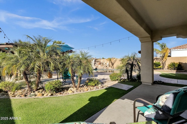 view of yard featuring fence and a patio