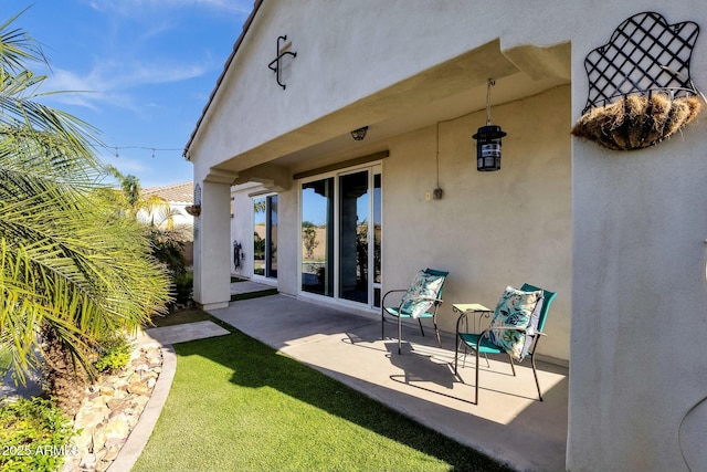 rear view of property featuring a patio area and stucco siding