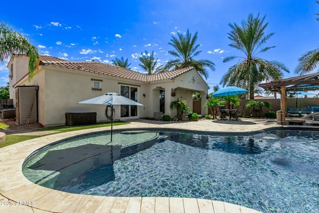 view of pool with fence, a jacuzzi, a fenced in pool, and a patio