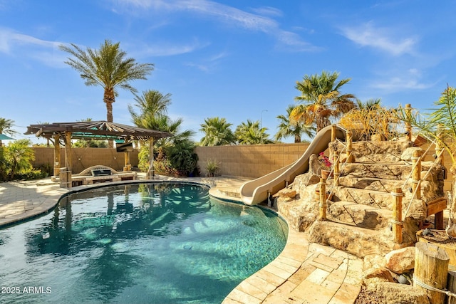 view of pool featuring a water slide, a gazebo, a fenced in pool, and a fenced backyard