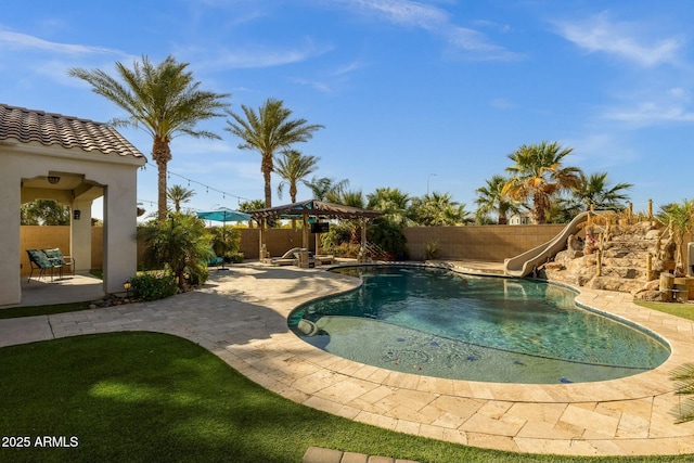view of swimming pool with a fenced in pool, a fenced backyard, a gazebo, a water slide, and a patio area