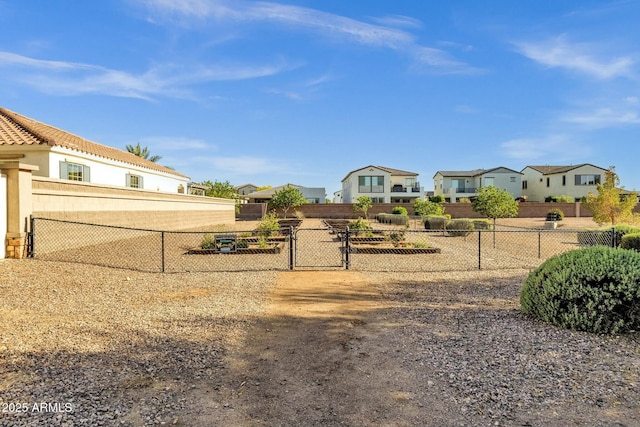 view of yard with a gate, a residential view, and fence