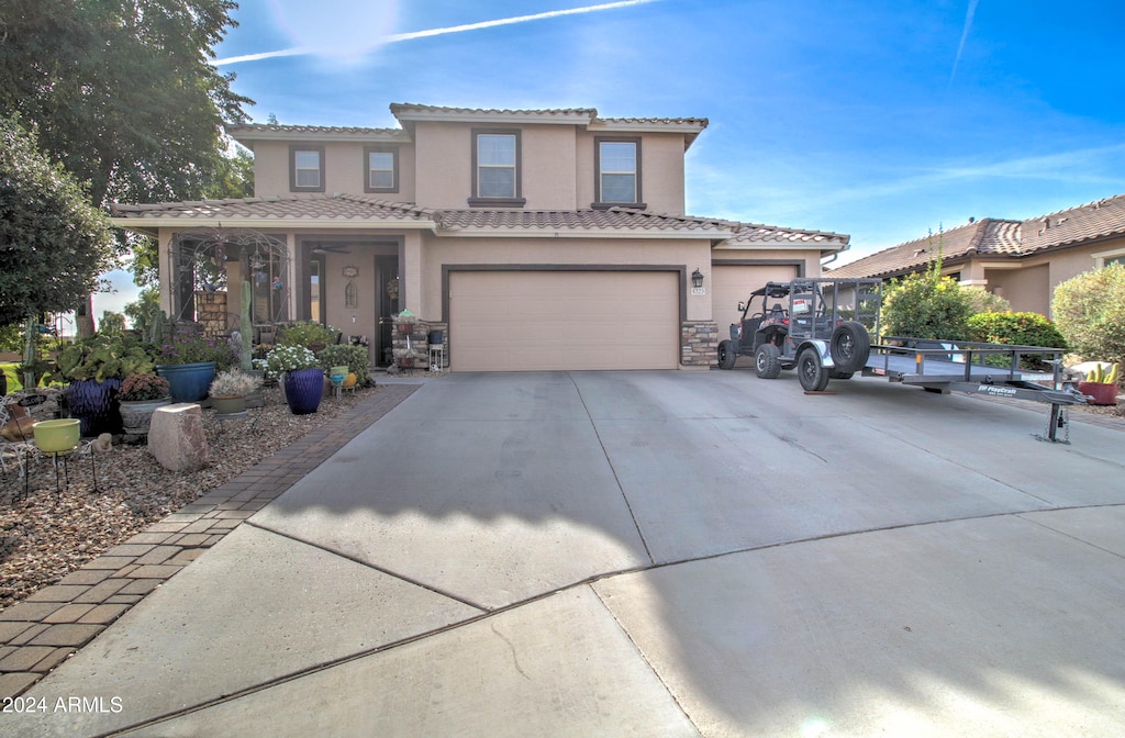 mediterranean / spanish home with a garage