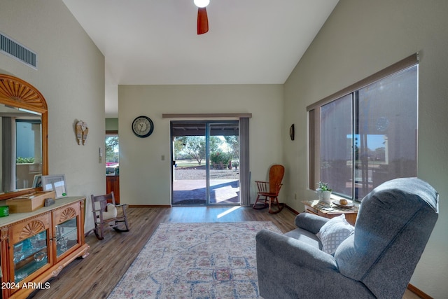 living room with light wood-type flooring, ceiling fan, and lofted ceiling