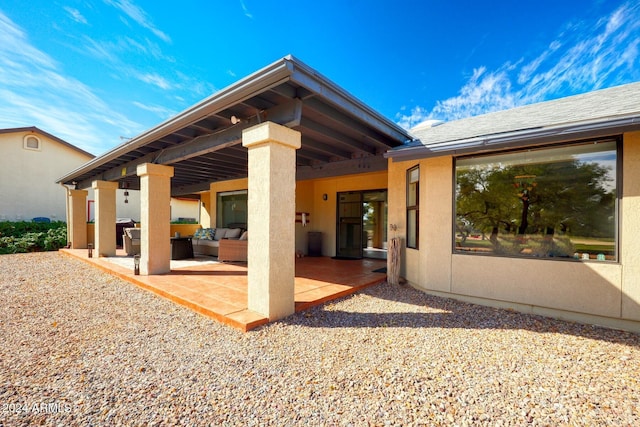 rear view of property featuring an outdoor hangout area and a patio