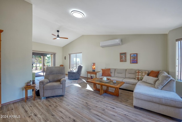 living room with ceiling fan, vaulted ceiling, light hardwood / wood-style flooring, and a wall mounted AC