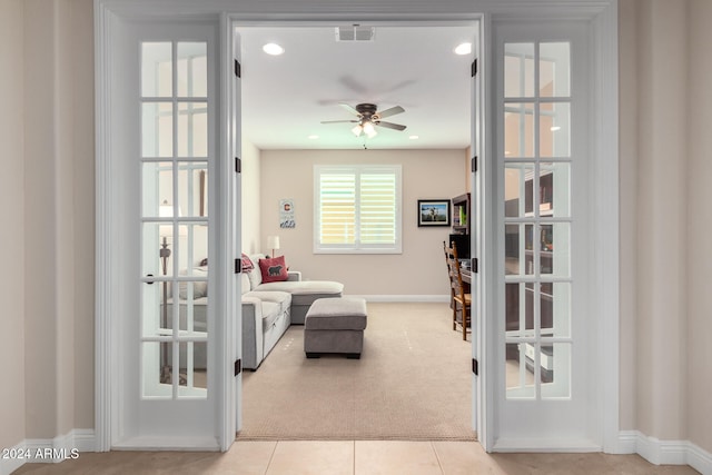 interior space with light carpet and ceiling fan