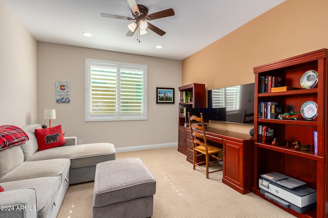 carpeted office space featuring plenty of natural light and ceiling fan